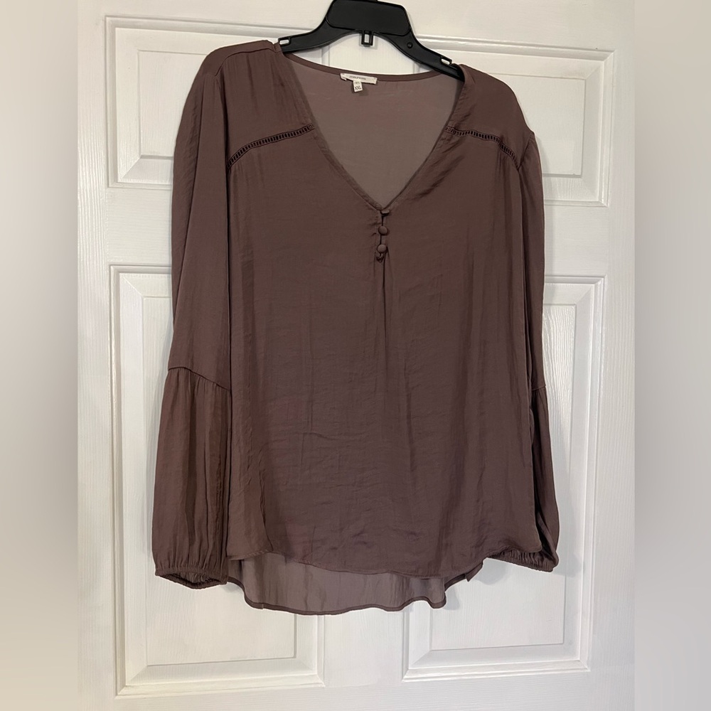 Coffee colored top with button details and puff sleeve details.